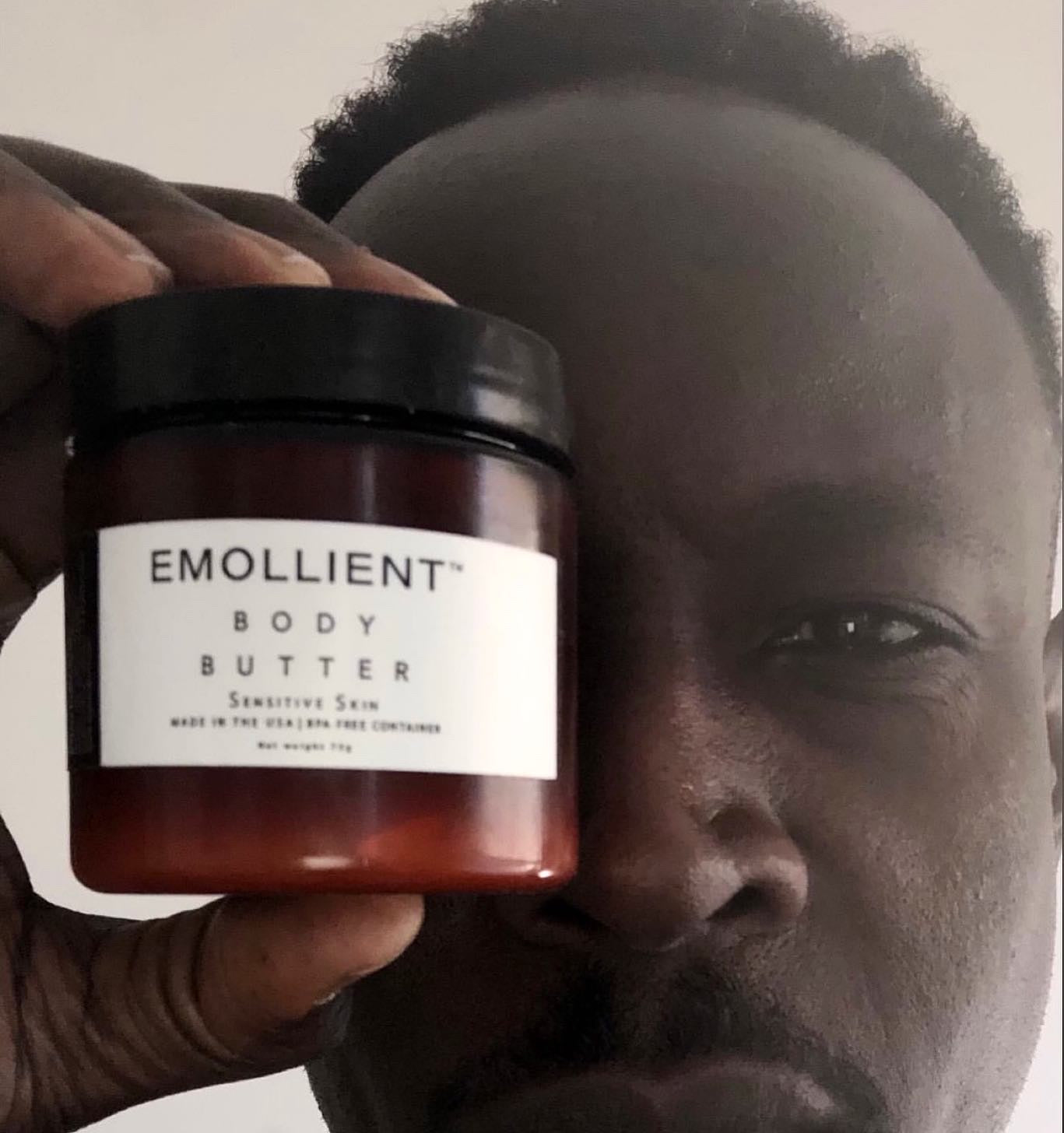 Black man holding jar of moisturizer