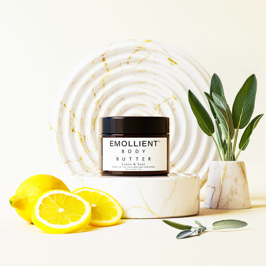 lemon and sage body butter with slices of lemon and sage leaves on a pedestal